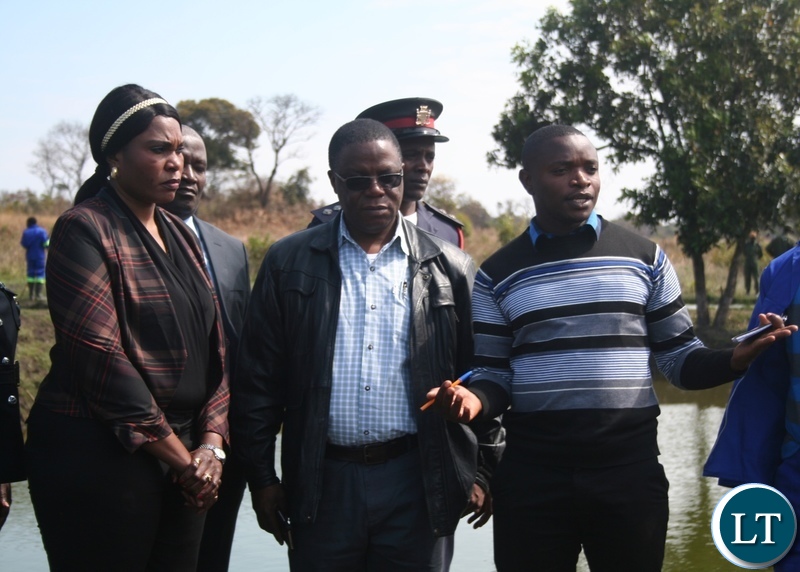 Congolese Lualaba province vice governor Fin Saini (l) and North-Western province minister Nathaniel Mubukwanu are shown fish ponds by Kalumbila district fisheries officer Matthus Lungu (r ) at Fawine farms in Kalumbila district on Thursday. PICTURE BY BETRAM KAOMA (ZANIS)