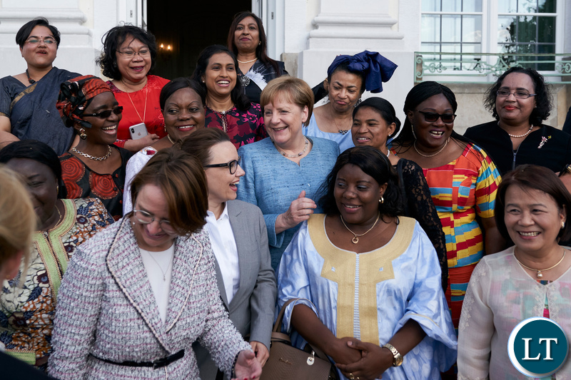 Chancellor Merkel shares a light moment with female African Ambassadors at the Schloss Meseberg