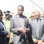 President Edgar Lungu talks to ministers during the tour of gutted COMESA Market