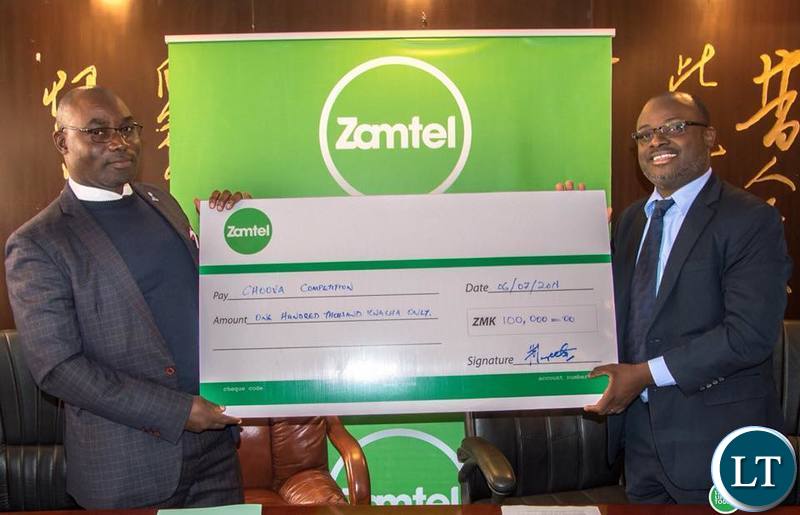 Sporrts Minister Moses Mawere receiving a K100,000 Kwacha from Zamtel CEO Sydney Mupeta