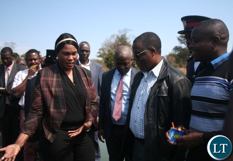 Congolese Lualaba province vice governor Fin Saini (l) and North-Western province minister Nathaniel Mubukwanu admire a small scale fish farm at Fawine farms as Kalumbila district fisheries officer Matthus Lungu (r ) looks on in Kalumbila