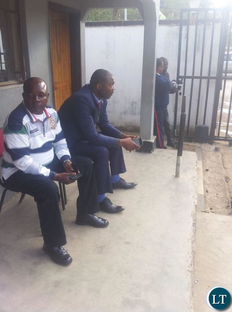 Lusaka Province Minister Bowman Lusambo manning the main entrance to his office to monitor late coming by civil servants.