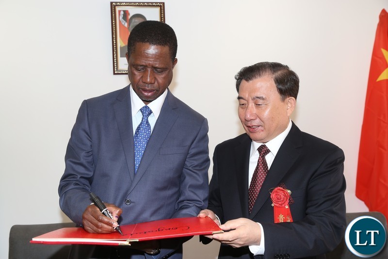 President Edgar Lungu signs a visitors book while Sinoma Chairman LIU Zhijiang looks on before the official opening of the China National Building Material Zambia Industry Plant in Chongwe District