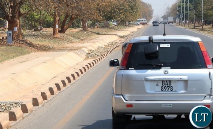 Installation of Speed Limit Cameras has brought sanity on same Lusaka roads. Here a motorist take precaution measure as they drive along great East road where Road Transport and Safety Agency (RTSA) has installed the cameras as a camera is seen on far left under the tree Installation of Speed Limit Cameras has brought sanity on same Lusaka roads. Here a motorist take precaution measure as they drive along great East road where Road Transport and Safety Agency (RTSA) has installed the cameras as a camera is seen on far left under the tree