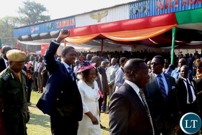 President Edgar Lungu flanked by Show Society President Caroline Silwamba wave to the crowd on his arrival in the main arena at the show ground