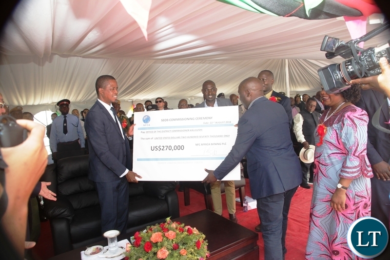President Edgar Lungu receives a cheque on behalf of Kalulushi Constituency from NFCA during the commissioning of NFCA mining project in Chambishi