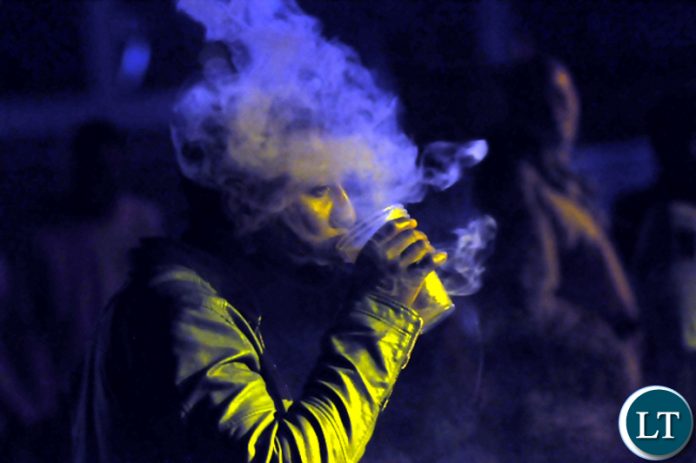 Shisha smoking is very popular in Zambia, though others want it banned. Here, an unidentified man puffs out smoke from a Shisha joint during the Africa Unite Concert in Lusaka recently