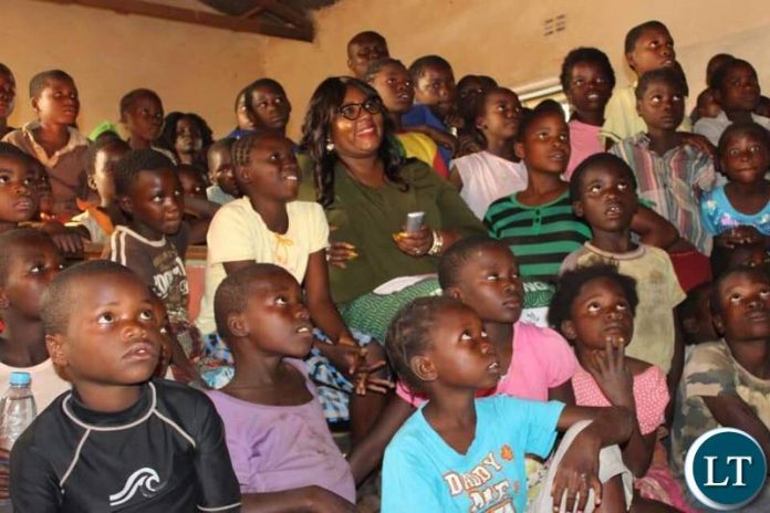 nformation and Broadcasting Services Minister who is also Chief Government Spokesperson & Petauke Member of Parliament Hon Dora Siliya MCC with kids at Chimunsi Primary School after the launch of the Satellite Village Television in Sinda District