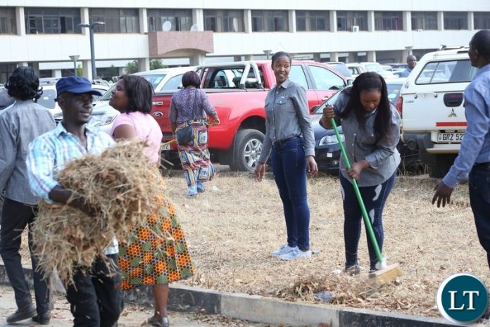 Ministry of Information Staffs joining in the keep Zambia Clean, Green and Healthy Campaign cleaning at Government Complex