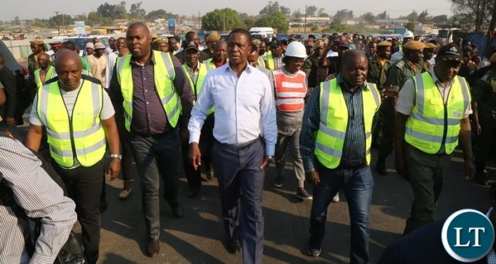 President Edgar Lungu flanked by Minister of Infrastructure Ronald Chitotela (2nr) RDA Chief Executive Officer Eng. Elias Mwape (r) Lusaka Province Minister Bowman Lusambo (2nl) and Special Assistant to the President Andrew Chellah (l) inspecting the progress on Lumumba roads President Edgar Lungu flanked by Minister of Infrastructure Ronald Chitotela (2nr) RDA Chief Executive Officer Eng. Elias Mwape (r) Lusaka Province Minister Bowman Lusambo (2nl) and Special Assistant to the President Andrew Chellah (l) inspecting the progress on Lumumba roads