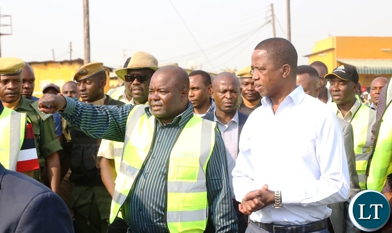 Minister of Infrastructure Ronald Chitotela explains on the progress of the road to President Edgar Lungu during the inspecting the progress on Lumumba roads