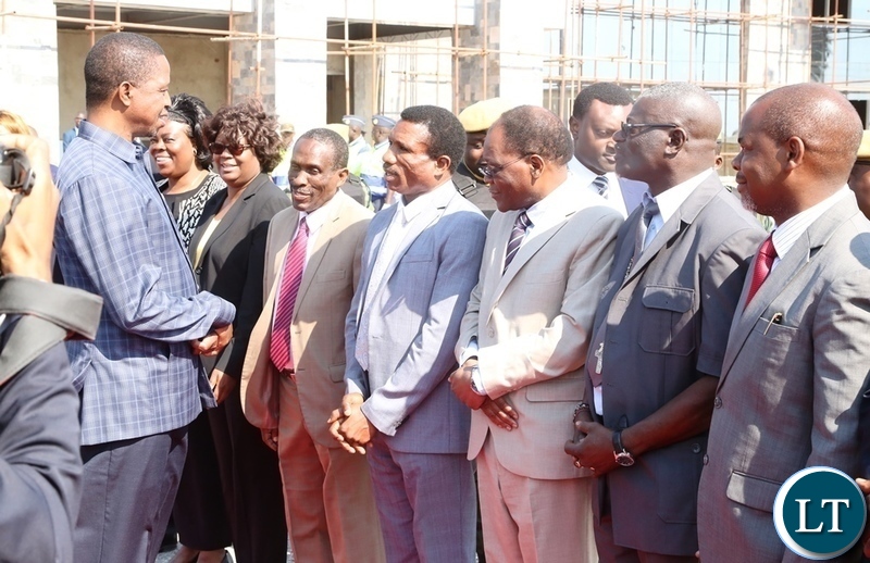 President Edgar Lungu confers with Minister of Agriculture Micheal Katambo whilst Cabinet Ministers and Secretary to Cabinet Rowland Msiska looks on shortly before his departure to Livingstone at Lusaka City Airport