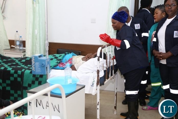 First Lady Esther Lungu cleaning at University Teaching Hospital (UTH) emergency ward during the keep Zambia Clean, Green and Healthy Campaign