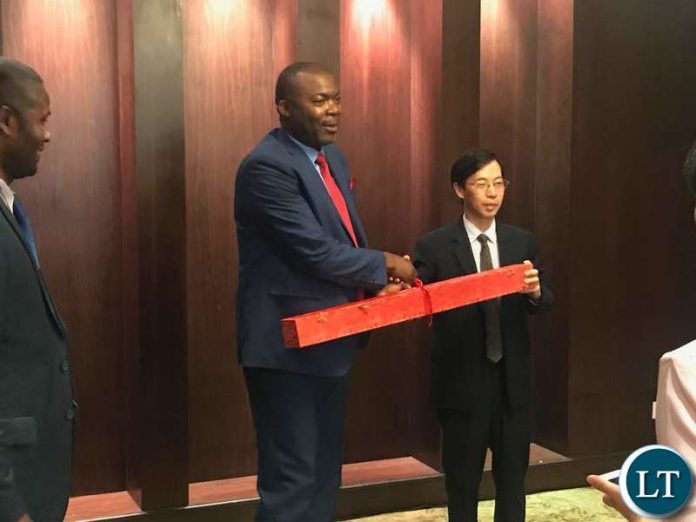 Lusaka Province Minister Bowman Lusambo receives a gift after touring China Railway Eryuan Engineering Group Company Head Offices in Chengdu City of China.