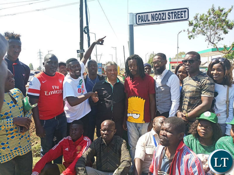Kabwata MP Given Lubinda unveils the Paul Ngozi streets flanked by Paul Ngozi Jr In red T-shirt) and musicians