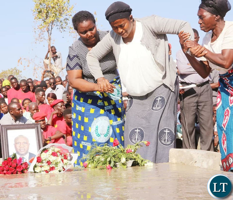 Late Mangango MP Naluwa Mweene’s widow helped as he lays wreaths on the grave