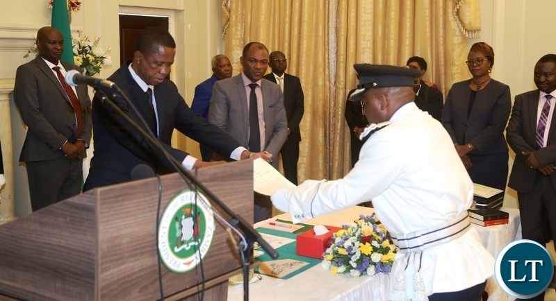 President Edgar Lungu receives the latter of Oath from the newly appointed Deputy Inspector General of Police Bonny Kapeso during swearing in ceremony at State House