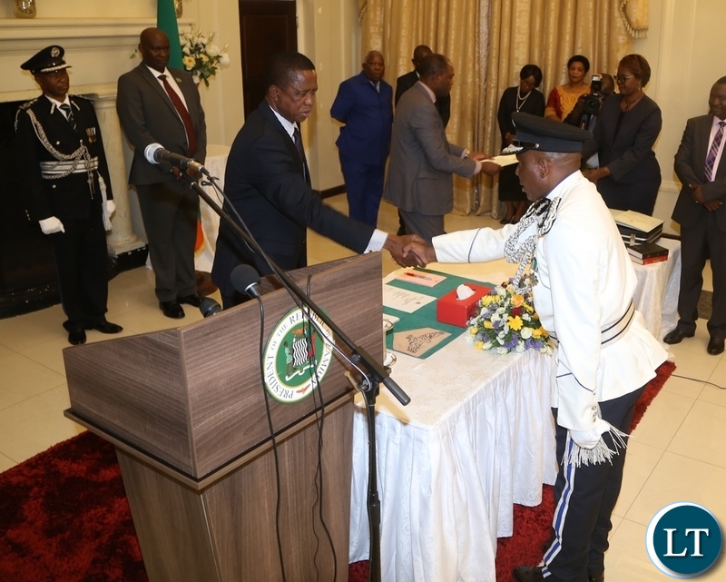 President Edgar Lungu congratulates the newly appointed Deputy Inspector General of Police Bonny Kapeso shortly after presenting his latter of Oath to the President at State House