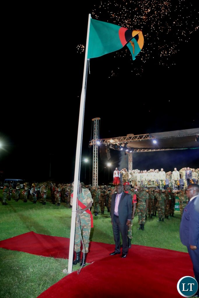 Minister of Defence Davies Chama observe the moment silent shortly after Hoisting the Zambian Flag at Lusaka Show Grounds during the hoisting of the flag ceremony