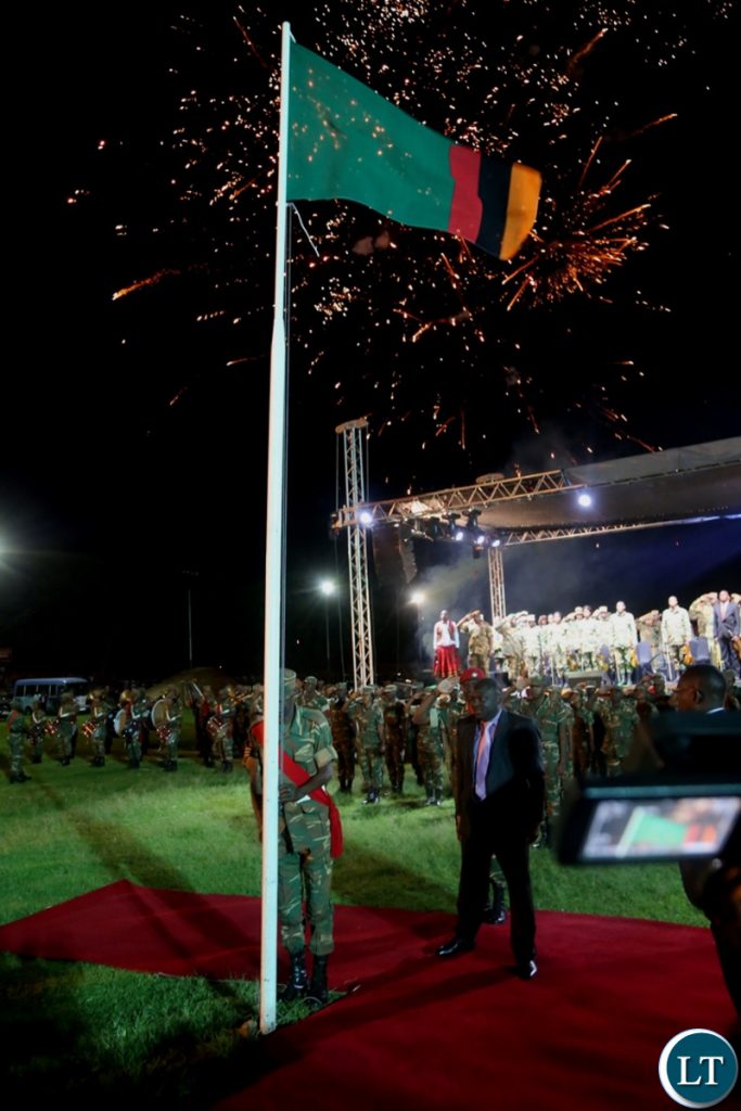 Minister of Defence Davies Chama observe the moment silent shortly after Hoisting the Zambian Flag at Lusaka Show Grounds during the hoisting of the flag ceremony
