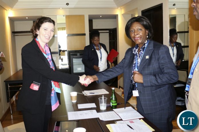 DFID Director General LINDY CAMERON shakes hands with Minister of Finance MARGARET MWANAKATWE after a bilateral meeting in Bali-Indonesia