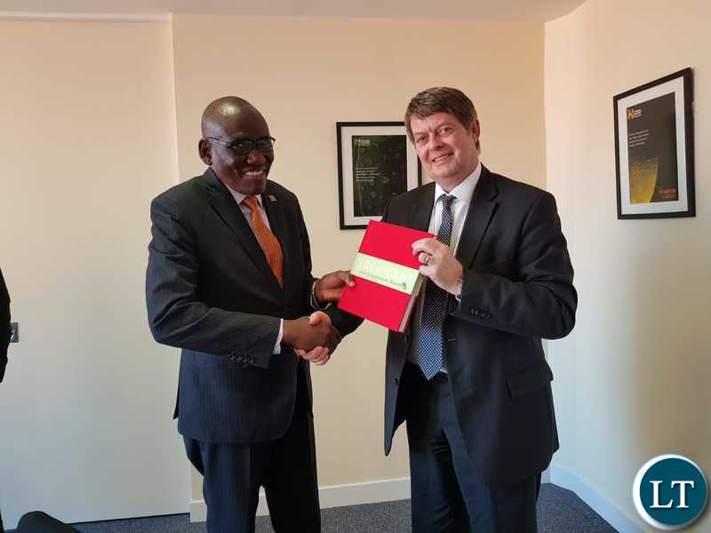 UK's National History Museum Director Sir Michael Dixion presenting a book to Tourism Minister Charles Banda at the Natural History Museum in London.
