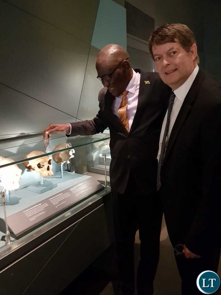Sir Michael Dixion showing Hon. Banda the skull of the Broken Hill man.