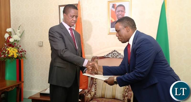 President Edgar Lungu recieves a report from Honourable Highvie Hamududu Special Advisor to the Presidency The SADC Election Observation Mission