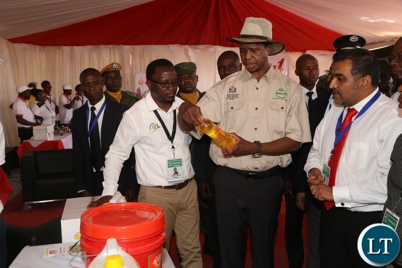 President Edgar Lungu samples mount meru millers products during the tour of stands before the official opening of the Central Province Investment Forum and Expo in Kapiri