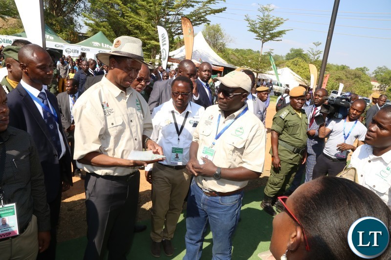 President Edgar Lungu samples Seed Co products during the tour of stands before the official opening of the Central Province Investment Forum and Expo in Kapiri District