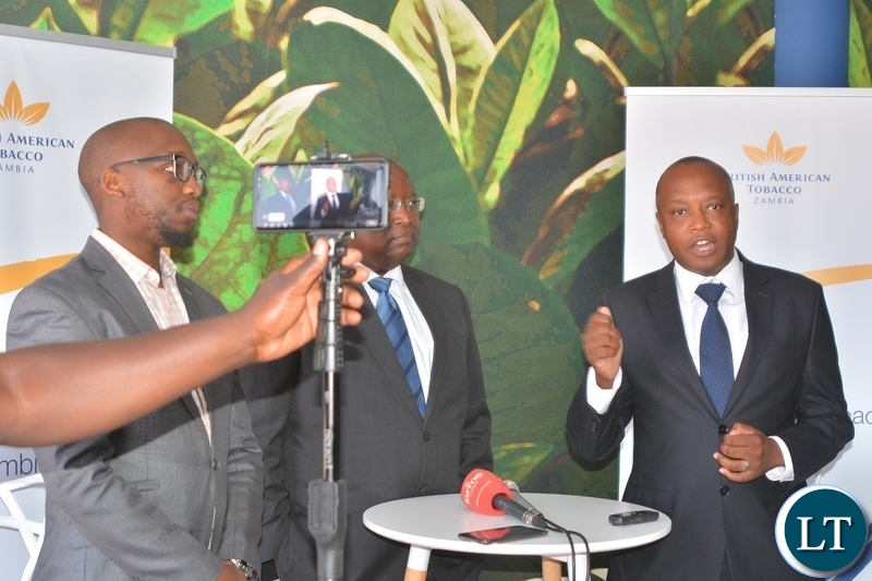 Director of British American Tobacco,Godfrey Machanzi(r) addressing the media during the tour of cigarette manufacturing factory company which has invested over $ 25 million in construction at the Multi Facility Economic Zone in Lusaka.Looking on is Head of operations,Jerry Chivambo(m) and Head of legal,Mdu Lokotfwako(left).