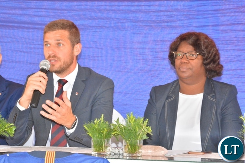 Minister in the office of the vice -President,Sylvia Chalikosa paying attention to the Head of Barcelona Academy world- wide,Carlos Martin during the official launch of Barcelona soccer academy, futsal and sports complex in Lusaka.