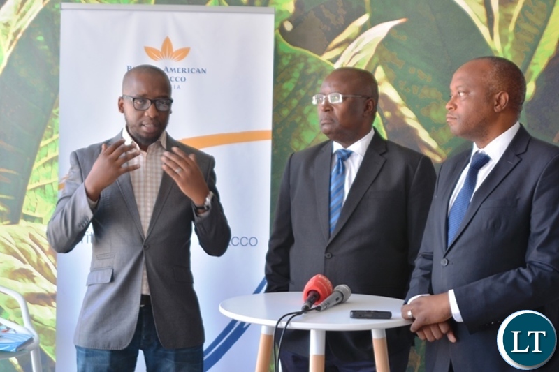 Head of legal,Mdu Lokotfwako(left) stressing a point during the media briefing on manufacturing factory company which has invested over $ 25 million in construction at the Multi Facility Economic Zone in Lusaka.Looking on is Head of operations,Jerry Chivambo(m). Director British American Tobacco,Godfrey Machanzi(r)