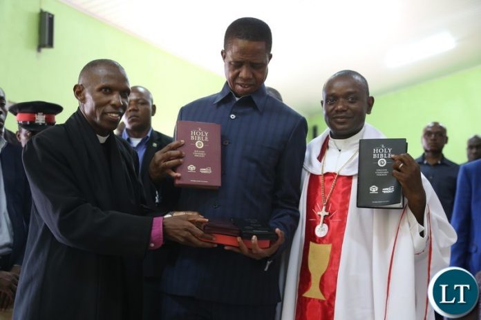 President Edgar Lungu receives some bibles from Bishop Sydney Sichilima (left) and Reverend Serge Changa during a church service at UCZ President Edgar Lungu receives some bibles from Bishop Sydney Sichilima (left) and Reverend Serge Changa during a church service at UCZ Lilayi