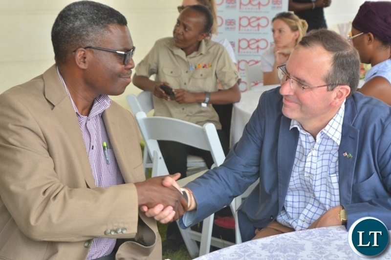 Director co-operatives,Shadrick Mugalaba greets British High commissioner,Fergus Cochrane-Dyet during the Zambian Artisan Awards in Lusaka.