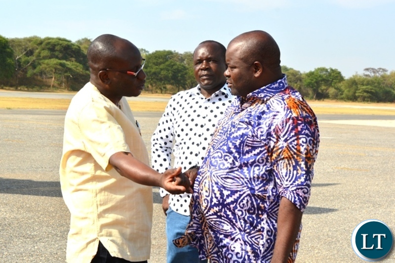 Presidential Assistant for Press and Public Relations,Amos Chanda(L) confers with Minister of Infrastructure,Ronald Chitotela(R) at City Airport.