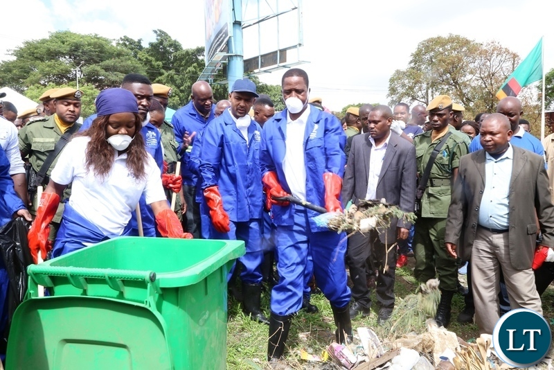 President Edgar Lungu cleaning during the Cavendish University Keep Zambia Clean, Health and Green at Kafue Roundabout