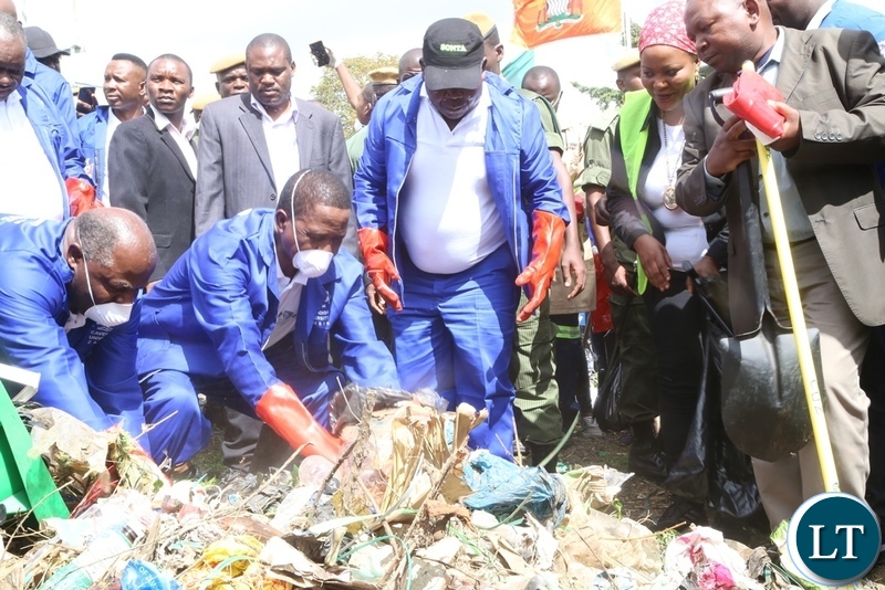 President Edgar Lungu cleaning during the Cavendish University Keep Zambia Clean, Health and Green at Kafue Roundabout
