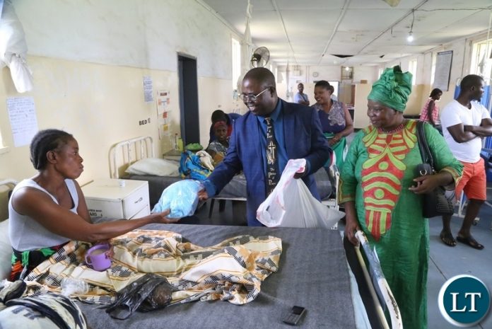 Bishop Joseph Ndashe flanked by his wife Dorothy Ndashe give Christmas gift to a patient Esther Zulu at Liteta Hospital during the giving of Christmas presents Bishop Joseph Ndashe flanked by his wife Dorothy Ndashe give Christmas gift to a patient Esther Zulu at Liteta Hospital during the giving of Christmas presents