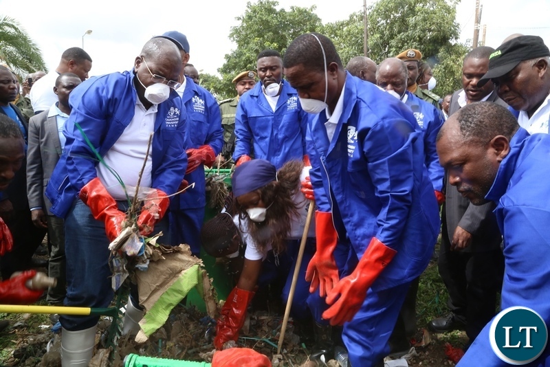 President Edgar Lungu and Minister of Health Chitalu Chilufya cleaning during the Cavendish University Keep Zambia Clean, Health and Green at Kafue Roundabout