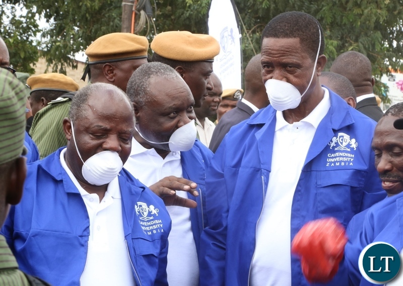 Cavendish University Vice Chancellor Dr. Kalombo Mwansa flanked by Cavendish University Council Chairperson Dr. Overs Banda confers with President Edgar Lungu during the Cavendish University Keep Zambia Clean, Health and Green at Kafue Roundabout