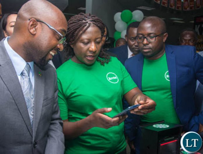 Transport and Communications Minister Brian Mushimba and Zamtel Acting Chief Information Officer Jason Mwanza look on as Zamtel Products Manager Mrs. Comfort Nyondo Mbulo demonstrates how ZamPay APP operates at Spar Arcades Transport and Communications Minister Brian Mushimba and Zamtel Acting Chief Information Officer Jason Mwanza look on as Zamtel Products Manager Mrs. Comfort Nyondo Mbulo demonstrates how ZamPay APP operates at Spar Arcades