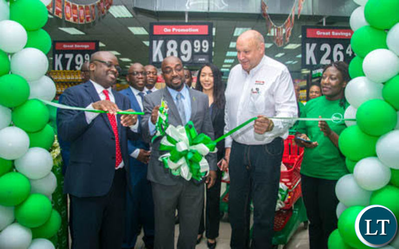 Transport and Communications Minister Brian Mushimba cuts the ribbon to launch ZamPay APP at Spar Arcades as Zamtel CEO Sydney Mupeta and Spar Zambia General Manager Ken Darvy look on