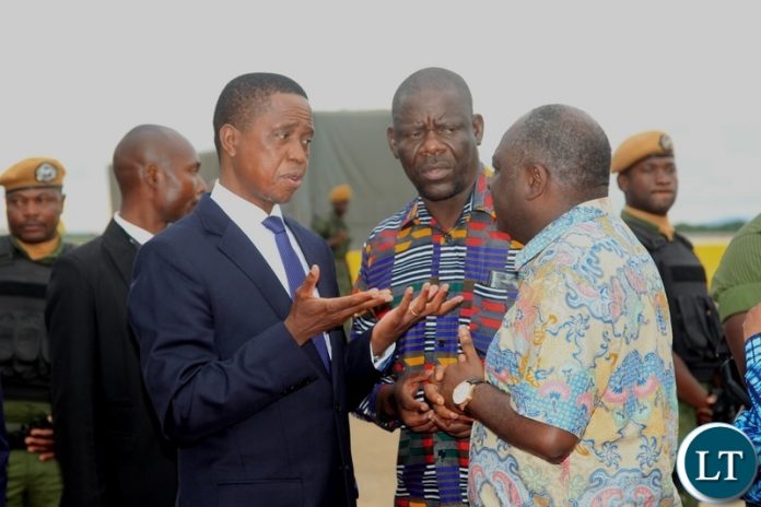 President Edgar Lungu confers with Patriotic Front Secretary General Davies Mwila and Defence Minister Davies Chama before departure for Japan at Kenneth Kaunda International Airport