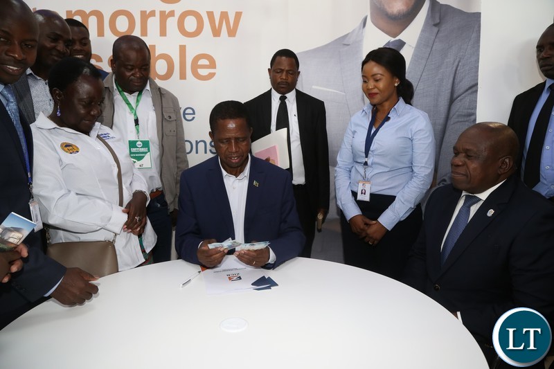 President Edgar Lungu depositing the money affter he opening an account with Zambia Industrial Bank before he officially opened the Edgar Chagwa Mall in Kitwe