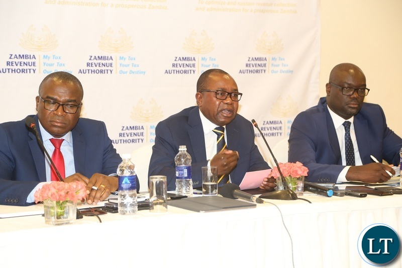 Zambia Revenue Authority (ZRA) Commissioner General Kingsley Chanda flanked by Commissioner Domestic Taxis Moses Shuko (l) and Commissioner Customs Sydney Chibbabbuka speaking to journalists during the press conference at Pamodzi Hotel
