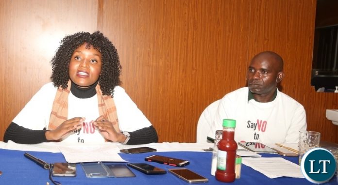 Community Technology Development Trust Project Manager Juliet Nangamba Luo flanked by Zambia Alliance for Agroecology and Biodiversity (ZAAB) member Emmanuel Mutamba speaking to journalists during ongoing National Concerns over Biosafety and GMO policy Shift media briefing at Kapingila House