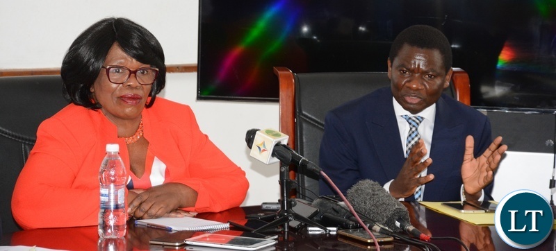 Minister of General Education David Mabumba flanked by Minister of High Education Nkandu Luo speaking to Journalists whilst listens during the Joint Media Briefing at Ministry of High Education