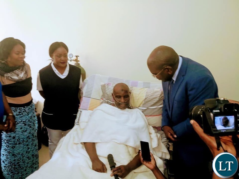 Health Minister Chitalu Chilufya visiting Former Vice President Lupando Mwape on his hospital bed at UTH