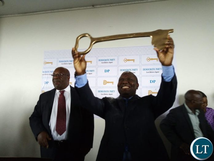 DA President Harry Kalaba shows the party symbol during the press briefing in Lusaka